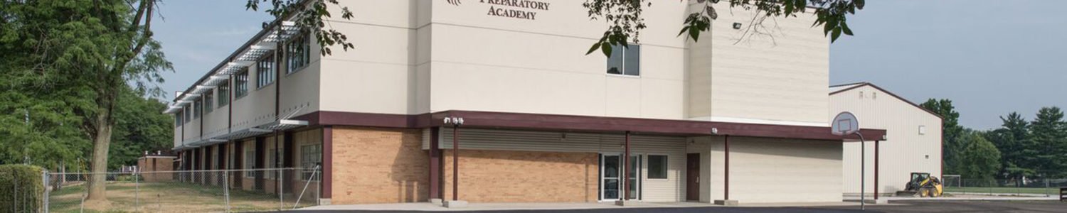 Exterior view of Patriot Preparatory Academy, a renovated school building with multiple levels and visible signage.