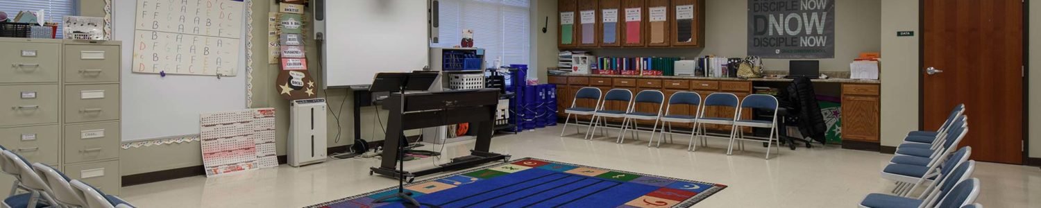 Music classroom at Grace Christian Middle School, featuring built-in cabinetry and ample space designed for musical instruction.