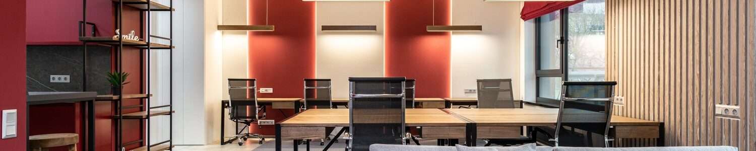 Shaping the Future of Non-Profit Architecture, community space in a bright lit room with red accents
