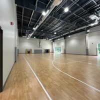 Multipurpose gymnasium at Ninth & O Baptist Church with a full basketball court and exposed ceiling