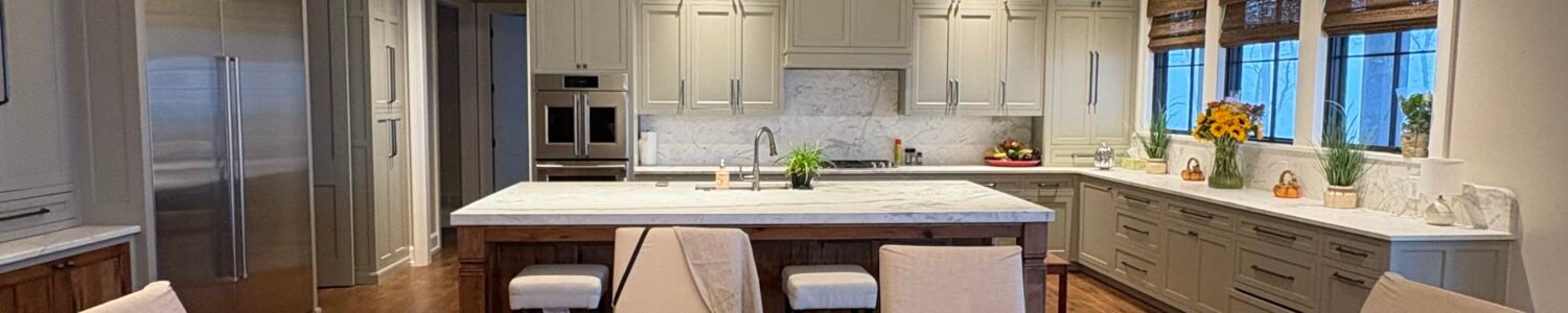 Open-plan kitchen and dining room with vaulted ceiling, wood beams, and a large island