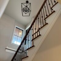 staircase with chandelier