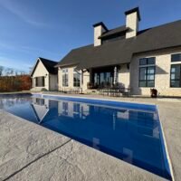 view of a pool outside behind a house