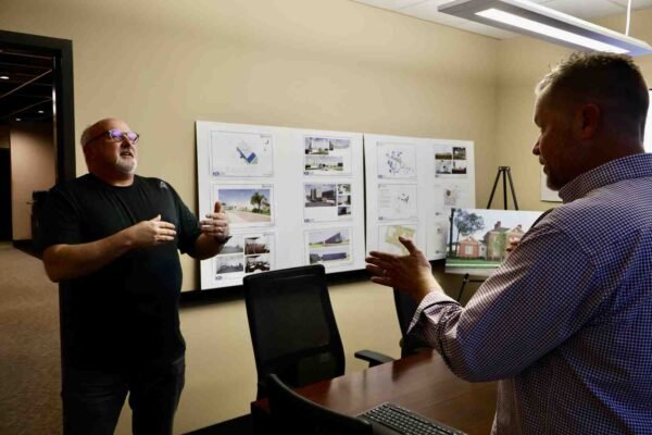 Building design services modern architectural workspace with blueprints and team collaboration - Building Design Services