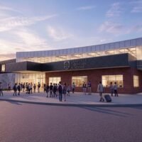 Rendering of Granville Christian Academy at sunset with students gathering outside the brick and glass main entrance